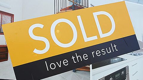 Sold sticker on real estate signboard (Getty)