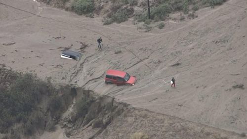 Cars submerged in LA mudslide following torrential rain and flash floods