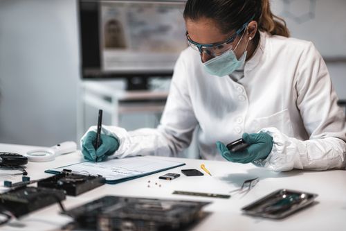 Digital Forensic Science. Police Forensic Analyst Examining Confiscated Mobile Phone.