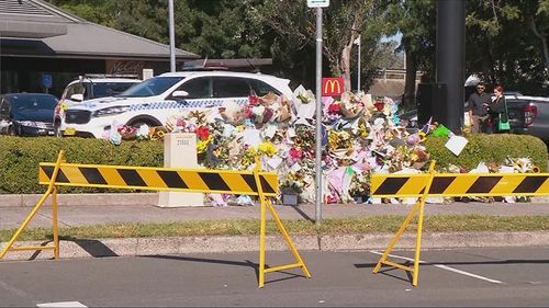 Slain paramedic Steven Tougher's family visit flower wall at Campbelltown McDonalds where he was allegedly stabbed to death.
