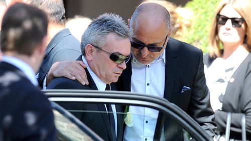 Borce Ristevski is comforted at the funeral of his wife Karen. Picture: AAP