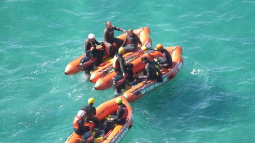 Rescuers search an area near Dunedin's Second Beach.