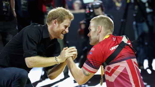 Prince Harry shakes the hand of Mark Omrod after he won second place at the Minute Indoor Rowing in the IR1 category at the Invictus Games at the Mattamy Athletic Centre in Toronto