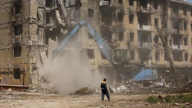 Russian Emergency Situations Ministry workers disassemble a destroyed building in Mariupol, in territory under the government of the Donetsk People's Republic, eastern Ukraine, Friday, May 27, 2022. (AP Photo/Alexei Alexandrov)