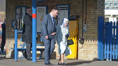Queen Elizabeth II walks alongside station manager Graeme Pratt as she arrives at King's Lynn railway station in Norfolk, ahead of boarding a train as she returns to London after spending the Christmas period at Sandringham House in north Norfolk.