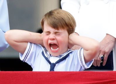 Prince Louis covers his ears as he watches a flypast from the balcony of Buckingham Palace during Trooping the Color on June 2, 2022 in London, England. 