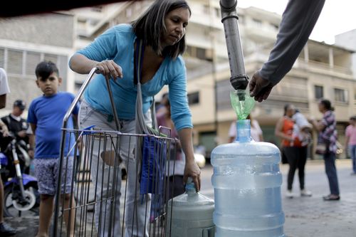 Locals in Venezuela venture the streets far and wide for rare sources of fresh water as mass blackouts continue throughout the country.