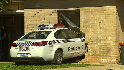 A police car has ploughed through the front room of a home in Adelaide's northern suburbs after responding to a disturbance incident.