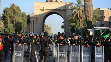 A file photo of Iraqi security forces stand guard outside the heavily fortified Green Zone during protests in Baghdad, Iraq in July.