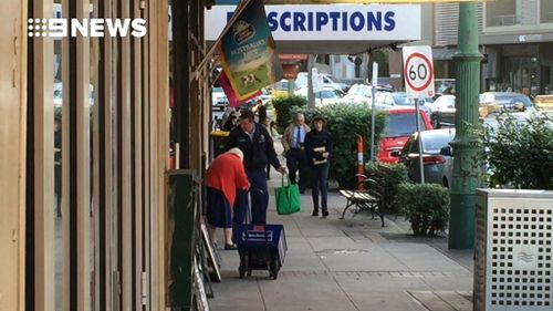 The officer carried the woman's bag and let her take her time. (9NEWS)