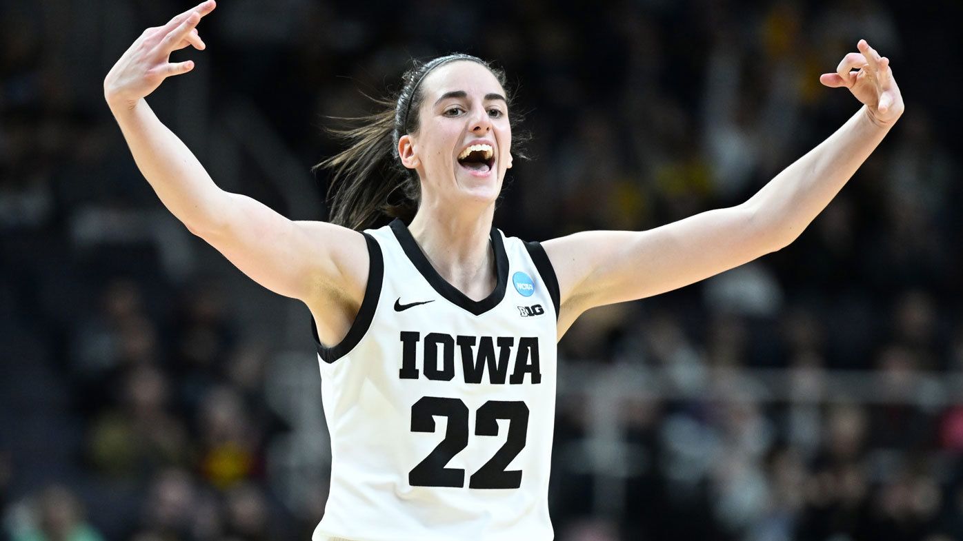 College basketball superstar Caitlin Clark celebrates after sinking a basket for Iowa.