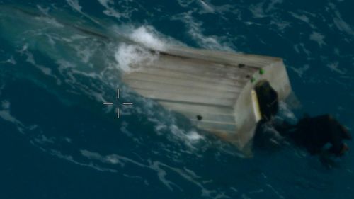 The man's dinghy was swamped by waves.