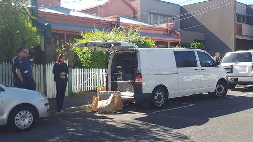 Bags of evidence were loaded into a police van. (9NEWS)