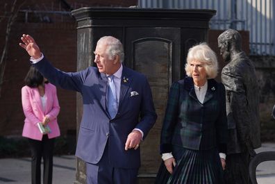 Prince Charles, Prince of Wales and Camilla, Duchess of Cornwall with a statue of CS Lewis and the wardrobe from the Lion the Witch and the Wardrobe during a tour of CS Lewis Square, Connswater Greenway, Belfast, to visit the stalls along the Narnia-themed sculpture walk, which showcase East Side Partnership's community activities, on the second day of their two-day visit on March 23, 2022 in Belfast, Northern Ireland.  