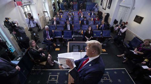 Donald Trump shows some documents to the White House press corps.