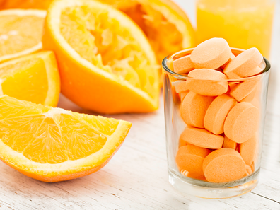 Vitamin C next to oranges