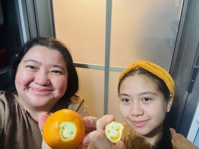 mother and daughter smiling orange 