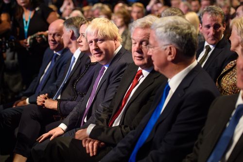 Boris Johnson listens on to the PM's speech. (AAP)
