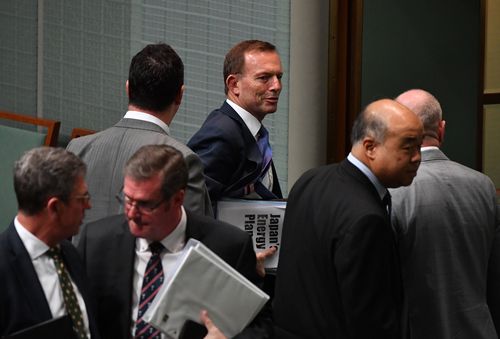 Former PM Tony Abbott, rather obviously clutching some research notes on Japan's energy policy yesterday.
