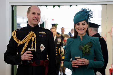 Prince William, Prince of Wales and Catherine, Princess of Wales laughing and enjoying a glass of Guinness after the St. Patrick's Day Parade at Mons Barracks on March 17, 2023 in Aldershot, England. 