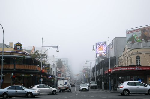 Fog obscures the view down Hindley Street in the Adelaide CBD this morning. Picture: AAP