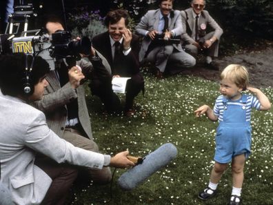 A young Prince William charms the press during a photocall for his second birthday in the gardens of Kensington Palace on June 12, 1984