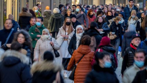 People walk through the main shopping street in Frankfurt, Germany on November 10, 2021.