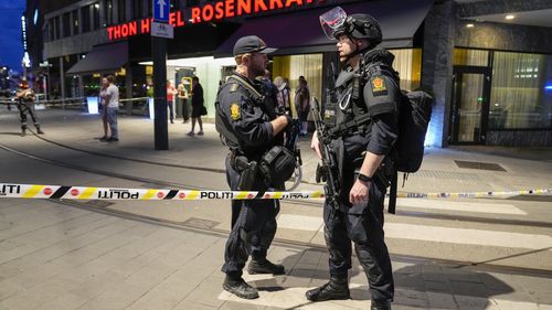 Police stand guard outside a bar in central Oslo, early Saturday, June 25, 2022. Norwegian police say a few people have been killed and more than a dozen injured in a mass shooting. (Javad Parsa/NTB via AP)