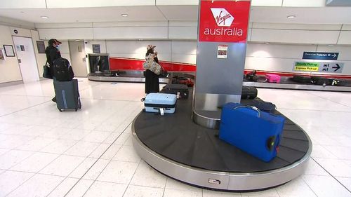 Passengers from Adelaide flight arrive in Sydney.