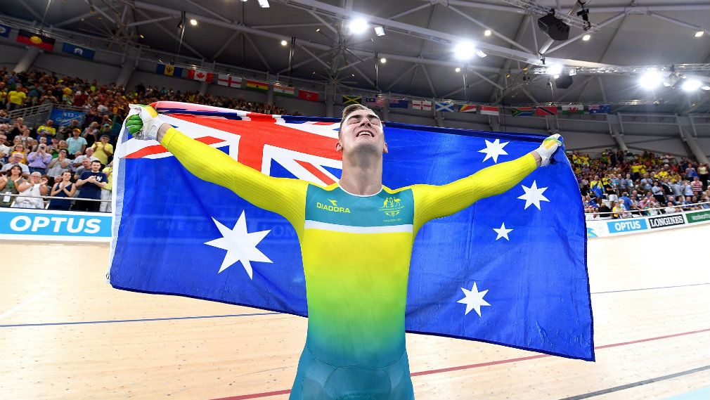 Matt Glaetzer carries the Australian flag after winning gold in the men&#x27;s keirin during day two. (AAP)