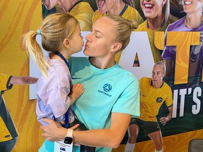 Tameka Yallop of the Matildas with daughter Harley.
