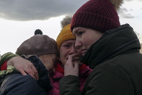 Ukranian refugees cry as they reunite at the Medyka border crossing, Poland, Saturday, Feb. 26, 2022. (AP Photo/Visar Kryeziu)