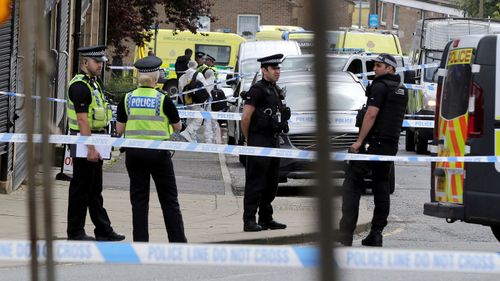 Officers rope off the crime scene after the shooting. (AAP)