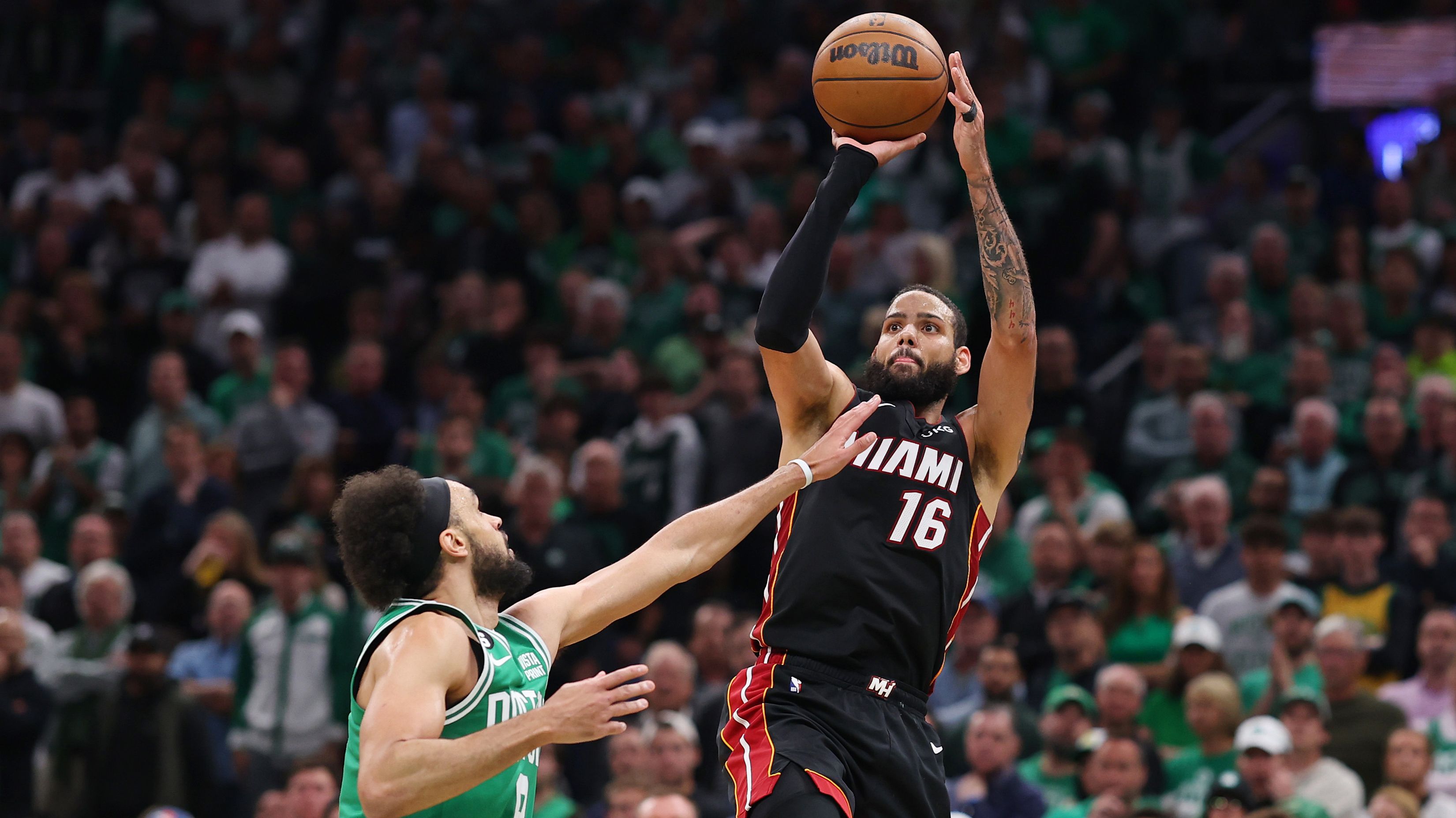 BOSTON, MASSACHUSETTS - MAY 29: Caleb Martin #16 of the Miami Heat attempts a three point basket against Derrick White #9 of the Boston Celtics during the third quarter in game seven of the Eastern Conference Finals at TD Garden on May 29, 2023 in Boston, Massachusetts. NOTE TO USER: User expressly acknowledges and agrees that, by downloading and or using this photograph, User is consenting to the terms and conditions of the Getty Images License Agreement. (Photo by Maddie Meyer/Getty Images)