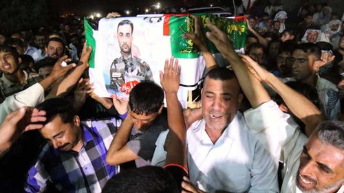 Iraqis attend the funeral of a member of Iraq's Shiite Badr militia. (AFP)