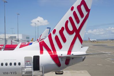 "Sydney, NSW, Australia - December 12, 2012: Virgin Australia plane with stairs waiting for passengers to board at Sydney Airport"