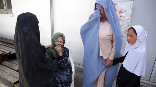 Mothers weep after losing their children in the deadly attack. (AP)