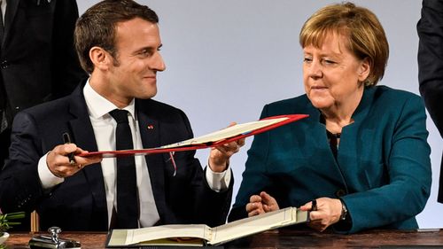 French President Emmanuel Macron and German Chancellor Angela Merkel sign the renewed friendship treaty in Aachen.