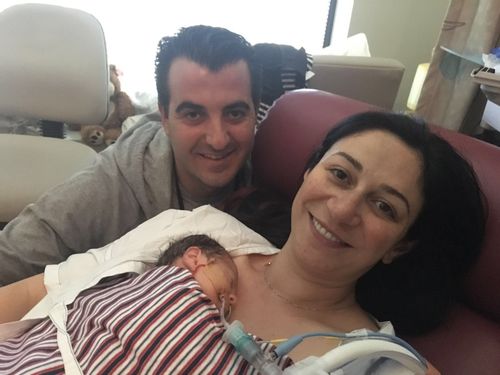 Nick and Elena with baby Angelo who was born January 13th, 2017, after doctors rushed mum Elena into surgery when Angelo's heartbeat started to drop.