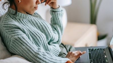 Woman with credit card on her laptop.