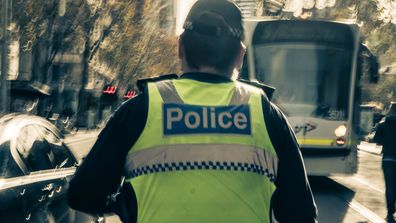 Melbourne Police officer patrolling in the city. Melbourne, Australia