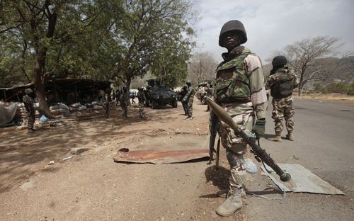 Nigerian soldiers man a checkpoint in Gwoza, Nigeria, looking for Boko Haram terrorists. (AAP). 