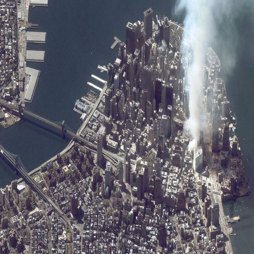 A satellite image of lower Manhattan shows smoke and ash rising from the site of the World Trade Center the day after the September 11 attacks.