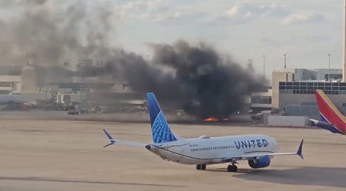 A plane has caught fire at Denver International Airport in the US, with social media footage showing smoke pouring from the engines.