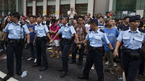 Police hold back demonstrators. (AAP)