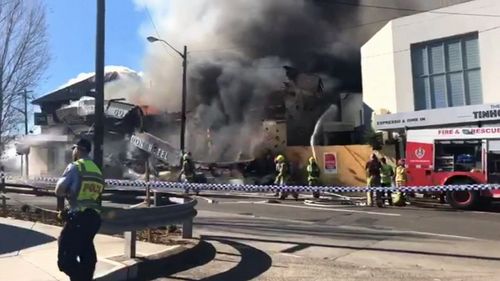 Road diversions also remain in place today as fire crews sift through the charred wreckage of the building. Picture: 9NEWS.