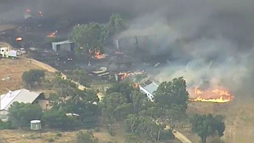 Local residents assisted in attempts to quell the blaze. (9NEWS)