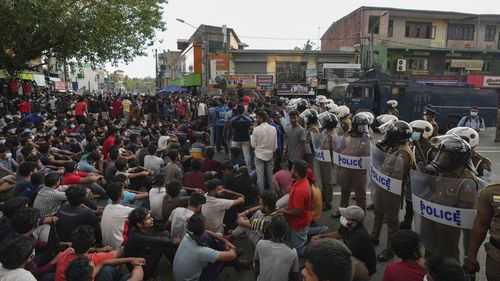 Hundreds of Sri Lankan protesters block a highway during a nationwide curfew in Colombo. 