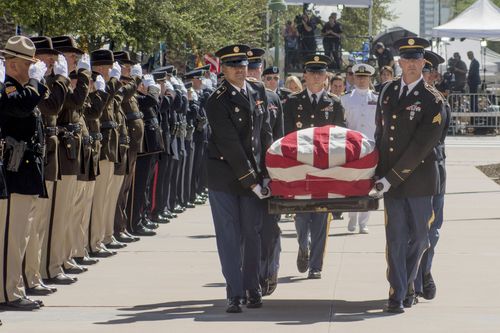 The Stars and Stripes covers the casket of John McCain, described as Arizona's 'favourite adopted son'.