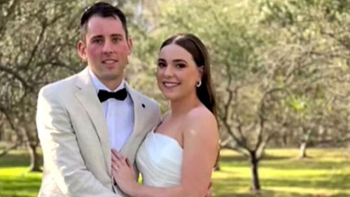 Mitchell Gaffney and Maddy Edsell embrace on their wedding day.